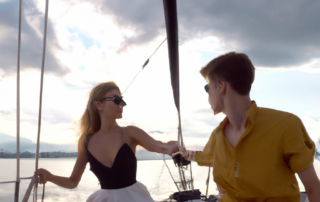 A fantastic young looking couple on a Yacht sailing